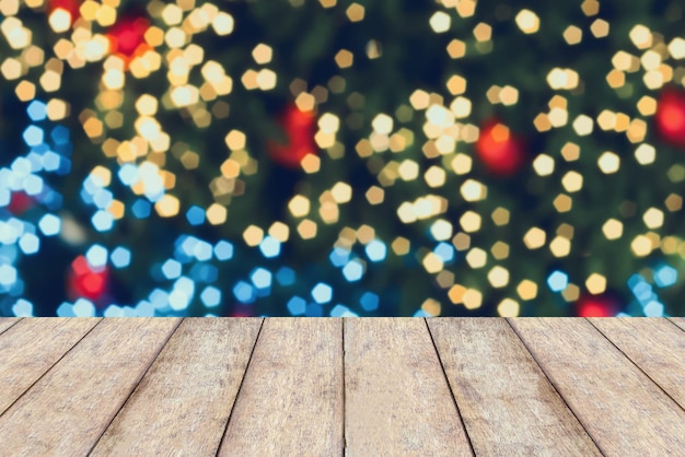 Christmas holiday background with wooden table top over bokeh light decorate on christmas tree