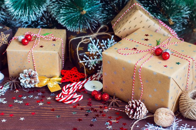 Christmas holiday gift box on decorated festive table with pine cones fir branches