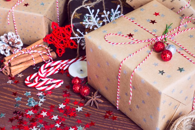 Christmas holiday gift box on decorated snow festive table with pine cones