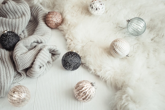Free photo christmas holiday still life with decorative toys and knitted sweater.