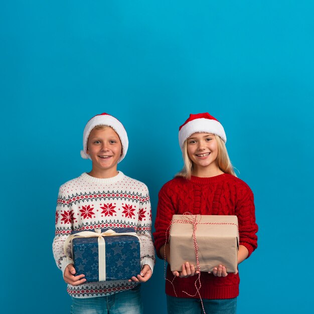 Christmas kids holding gifts studio shot
