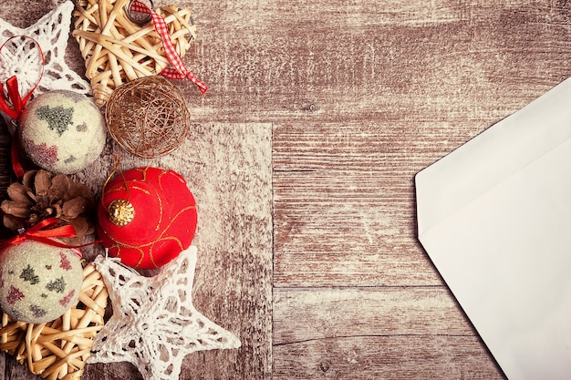 Christmas letter and ornaments in vintage toning on wooden background. Xmas message to the santa