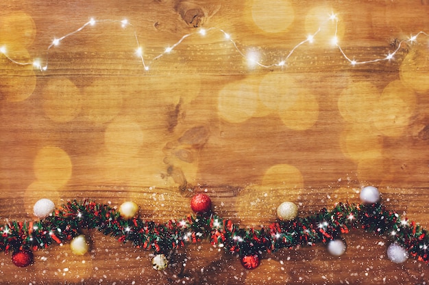 Christmas light garland on wooden background.