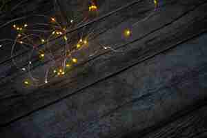 Free photo christmas lights on a wooden table