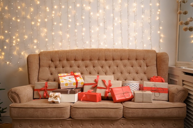 Free photo christmas living room with a christmas tree and presents on the sofa