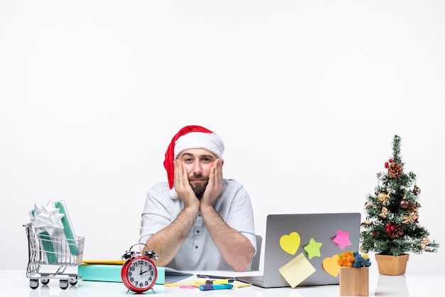 Christmas mood with unsatisfied busy young adult playing with his santa claus working