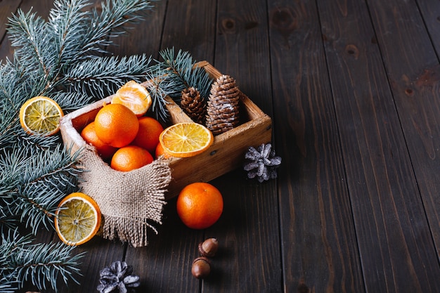 Christmas and New Year decor. Oranges, cones and Christmas tree branches 