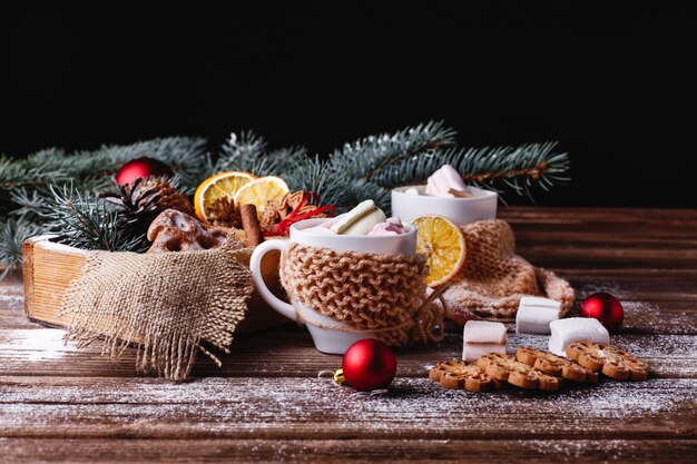 Christmas and New Year decor. two cups with hot chocolate, cinnamon cookies