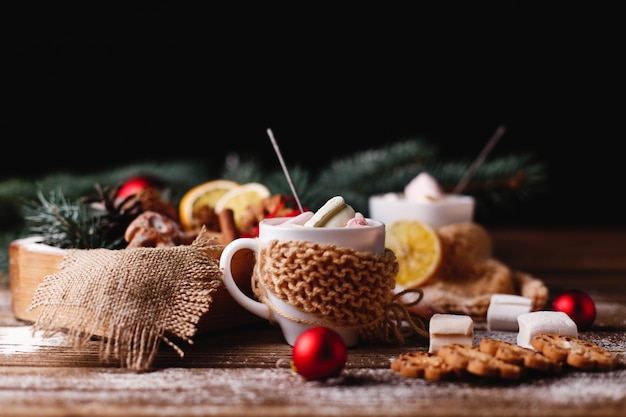 Christmas and New Year decor. two cups with hot chocolate, cinnamon cookies