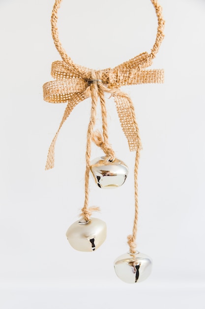 Christmas ornament with silver jingle bells on white background