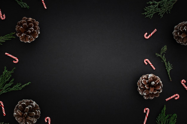 Free photo christmas ornaments and candy canes on dark background