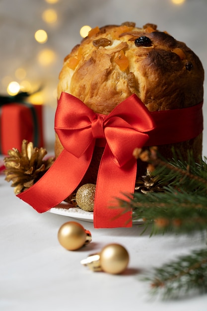 Free photo christmas panettone with red ribbon