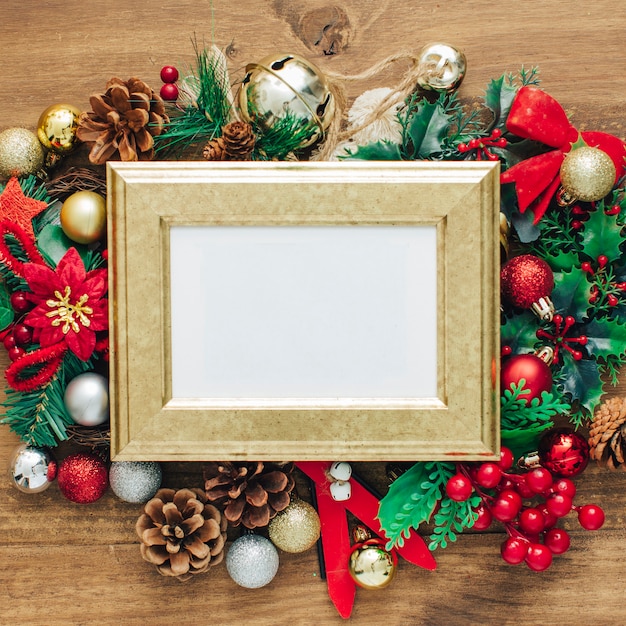 Christmas photo frame mock up template with decoration on wooden table.