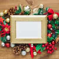 Free photo christmas photo frame mock up template with decoration on wooden table.