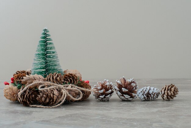 Christmas pine tree and wreath on marble.