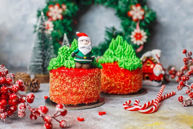 Christmas small cake decorated with sweet figures of christmas tree,santa claus and candles.