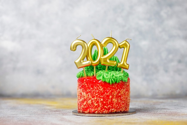 Christmas small cake decorated with sweet figures of christmas tree,santa claus and candles.