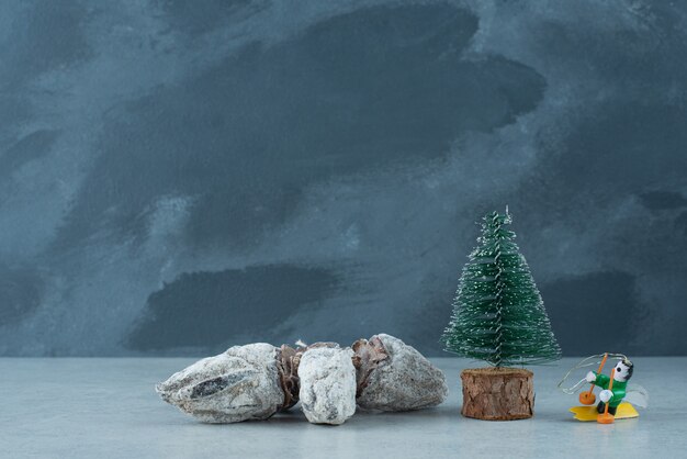 Christmas small tree with healthy dried fruits on marble background. High quality photo