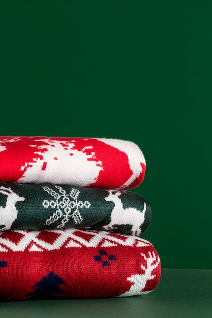 Christmas sweaters arrangement with green background