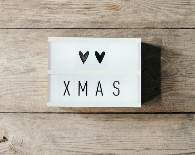 Christmas text in led panel with wooden background