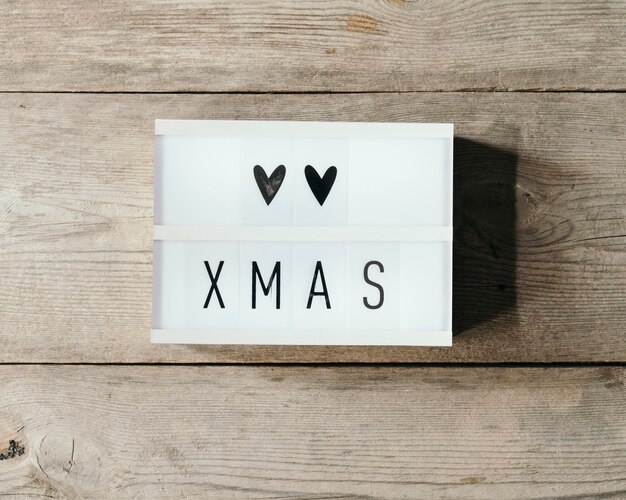 Christmas text in led panel with wooden background