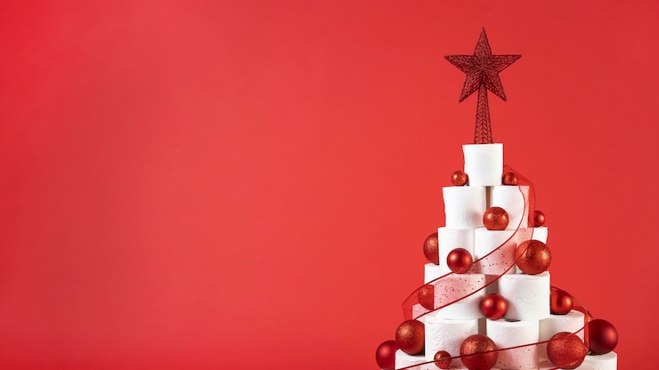 Free Photo christmas toilet paper tree on copy space red background