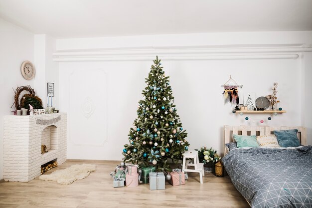 Christmas tree next to bed