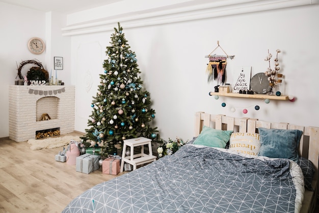 Christmas tree next to bed