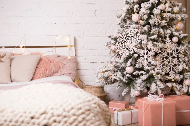 Christmas tree next to bed