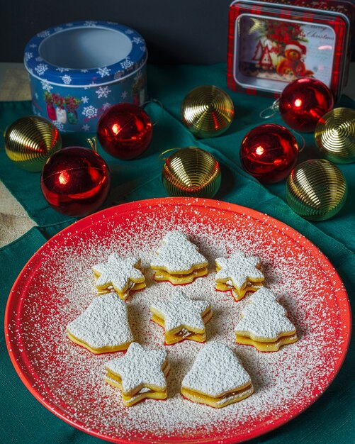 Christmas tree, bell and star cookies covered with powdered sugar