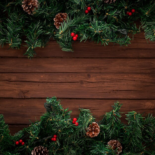 Christmas tree branches on wooden background