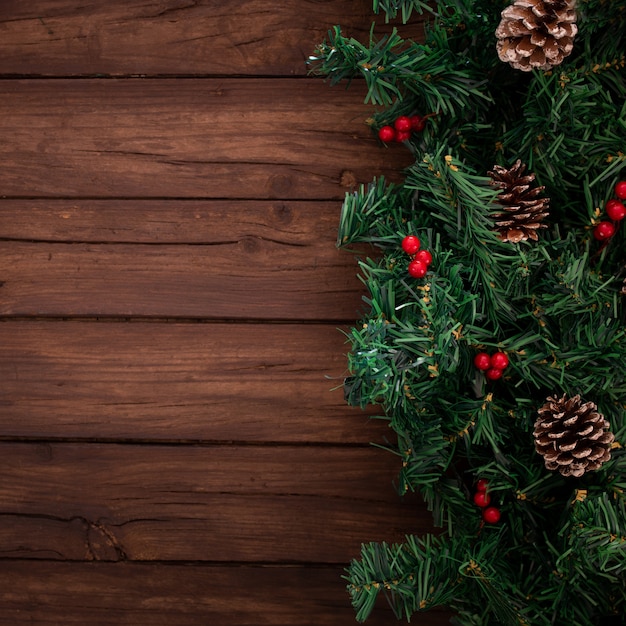 Christmas tree branches on a wooden background