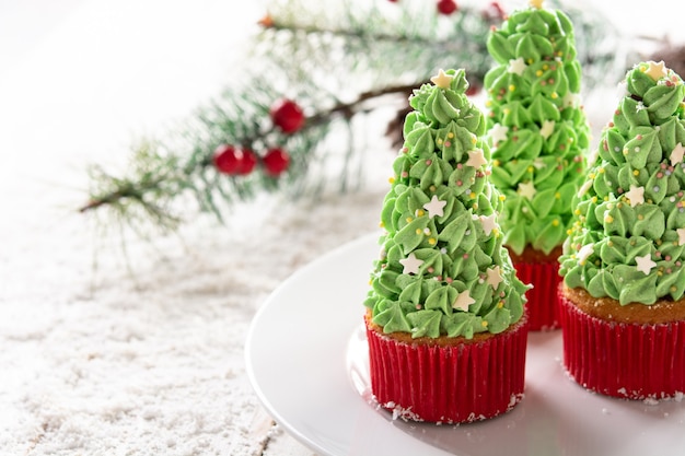 Christmas tree cupcakes isolated on white background