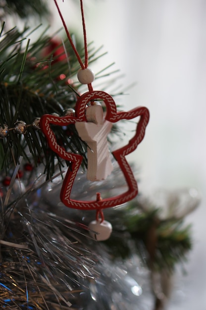 Christmas tree decoration of an angel hanging from the branches