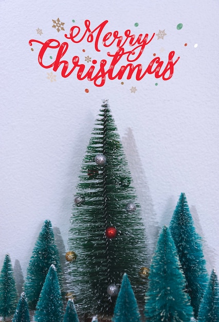 Christmas tree decoration and text merry christmas on wall background.