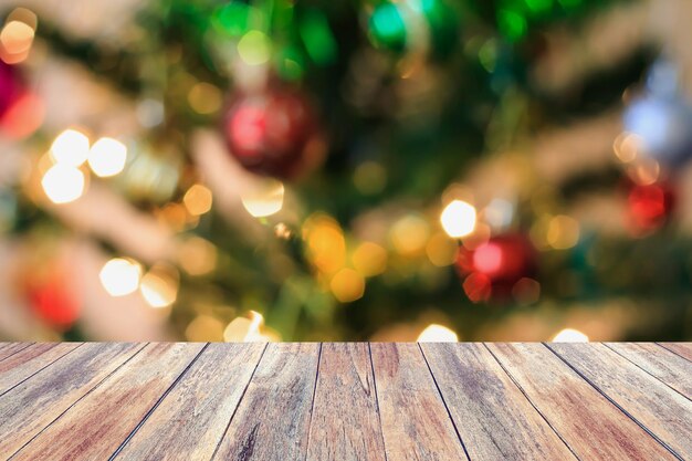 Christmas tree decorations bokeh light blur background with empty wood table, for create montage product display