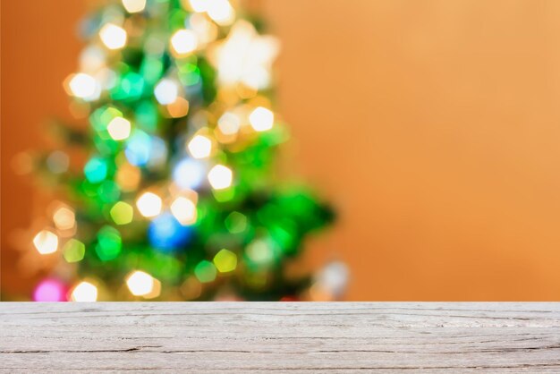 Christmas tree decorations bokeh light blur background with empty wood table