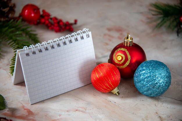 Christmas tree decorations round plastic toys xmas texture on pastel colours background