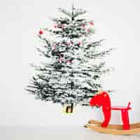 Free photo christmas tree and toy horse