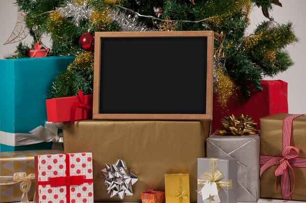 Christmas tree with gifts and blackboard