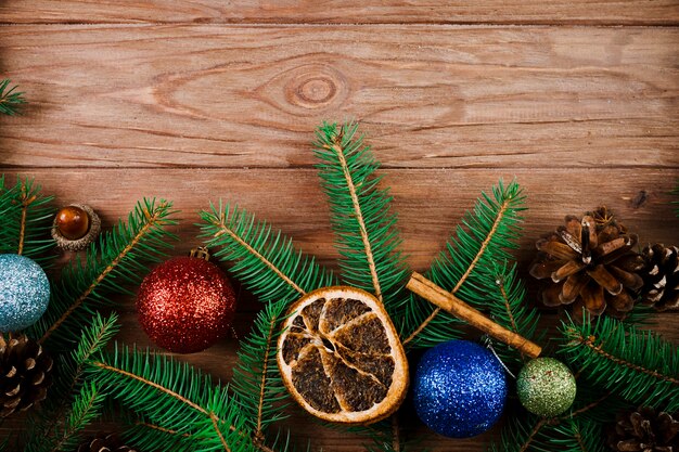 Christmas twig with ornament balls and dry lemon 