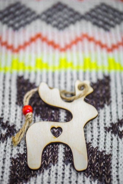 Christmas wooden toys on the of the sweater closeup