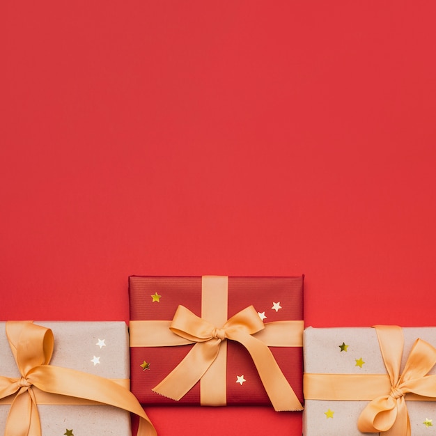 Christmas wrapped gift with stars on red background