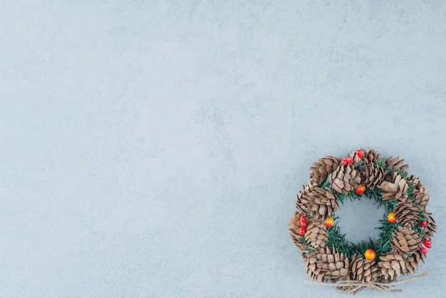 A Christmas wreath from pinecone on marble background. High quality photo