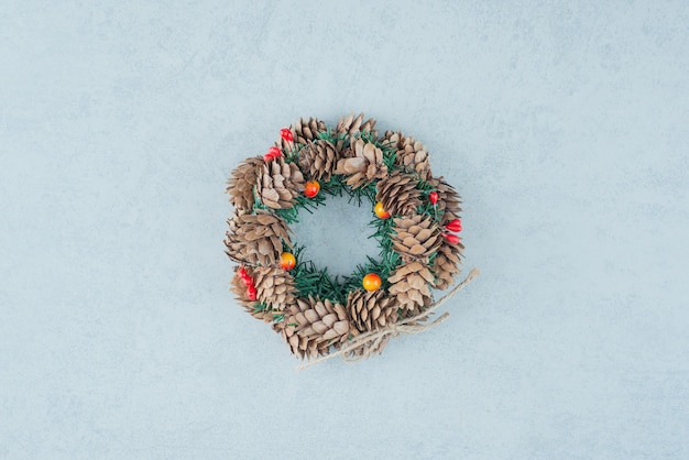 A Christmas wreath from pinecone on marble background. High quality photo