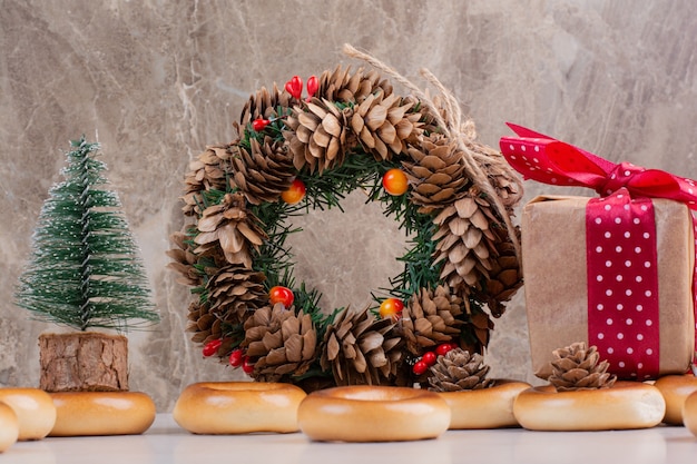 Christmas wreath from pinecones with cookies and small gift box. High quality photo