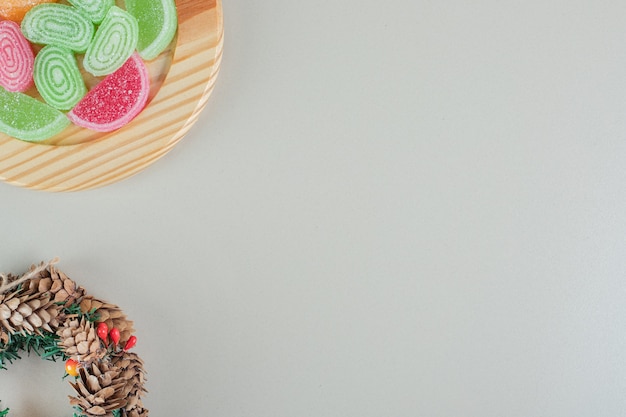 A Christmas wreath with colorful sugary marmalades .