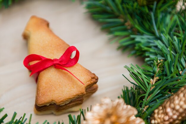 나무 배경 위에 쿠키와 크리스마스 화 환