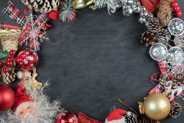 Christmas wreath with festive ornaments on dark surface