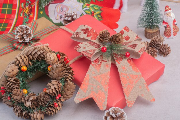 Christmas wreath with gift boxes on white surface